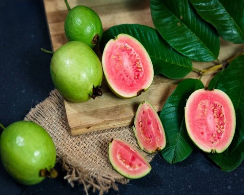 Red guava slices in a ceramic bowl ready to eat